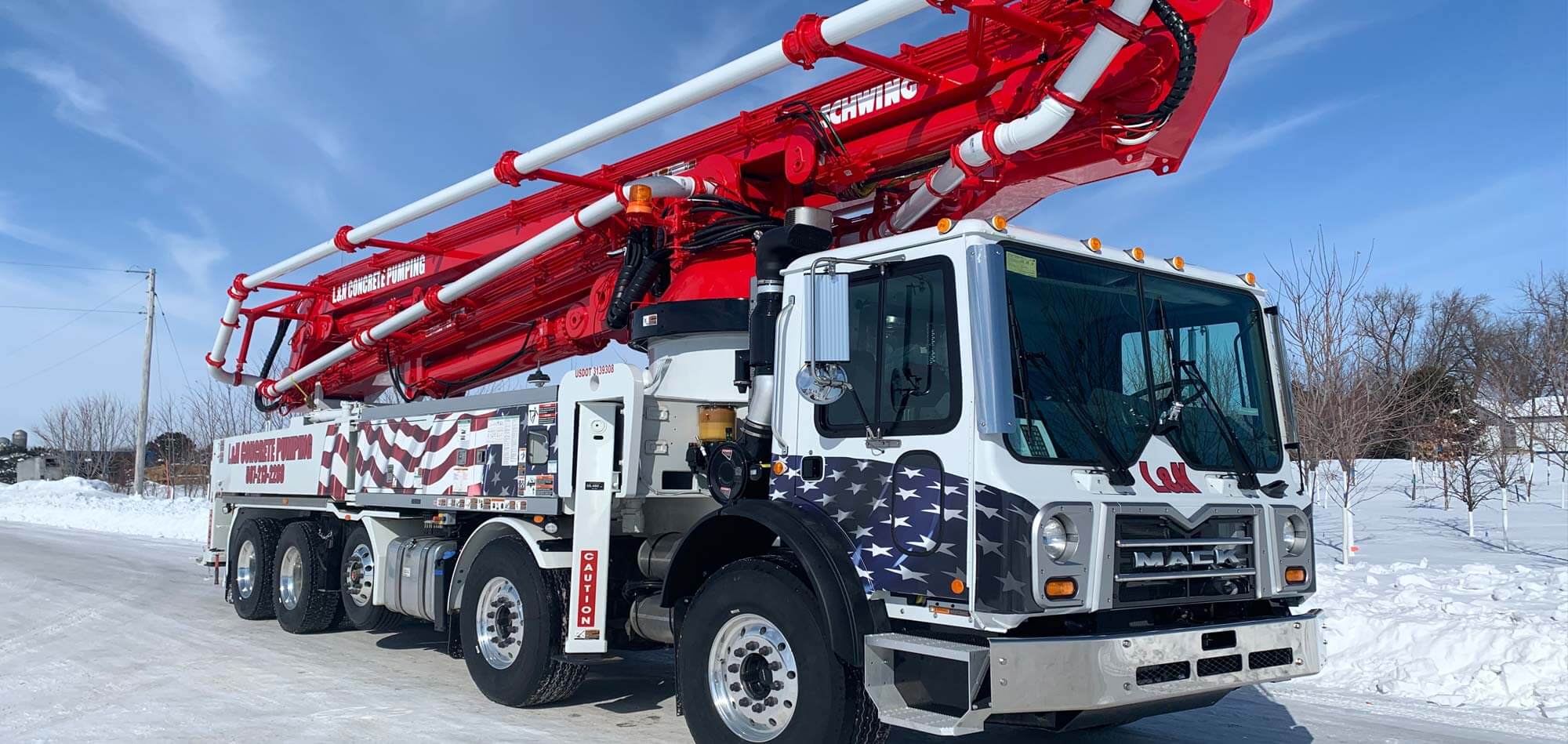New Concrete Pump Truck with an American Flag design owned by L&N Concrete Pumping with a Schwing Concrete Placing Boom